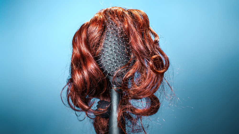 Hairbrush in "wig" made of red hair