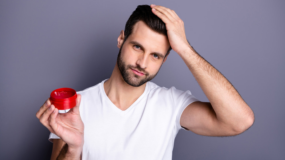 Man applying gel to his hair