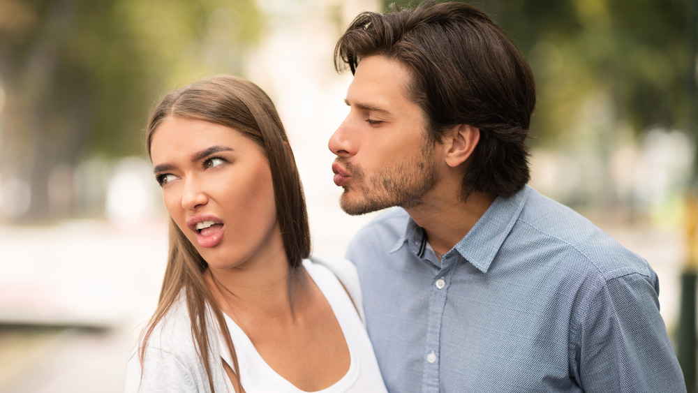 Woman disgusted by man trying to kiss her