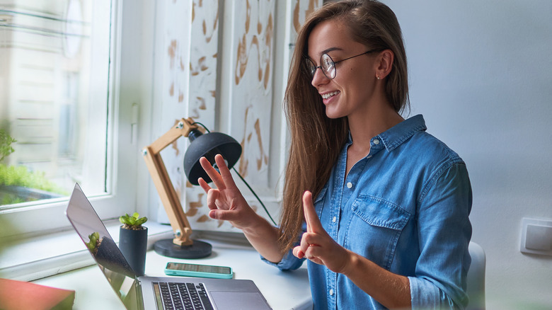 woman learning to speak sign language