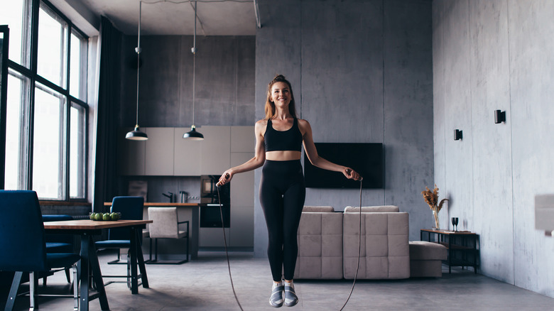 woman jumping rope in her home