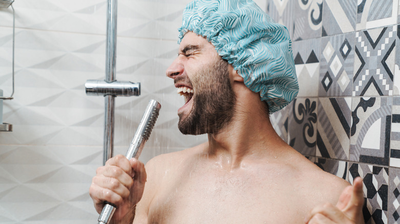 man singing in shower happily 