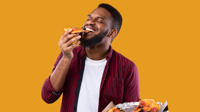 man eating pizza