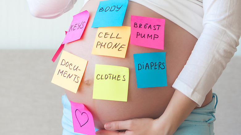pregnant woman with sticky notes on belly