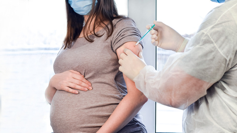 Pregnant woman receiving vaccine