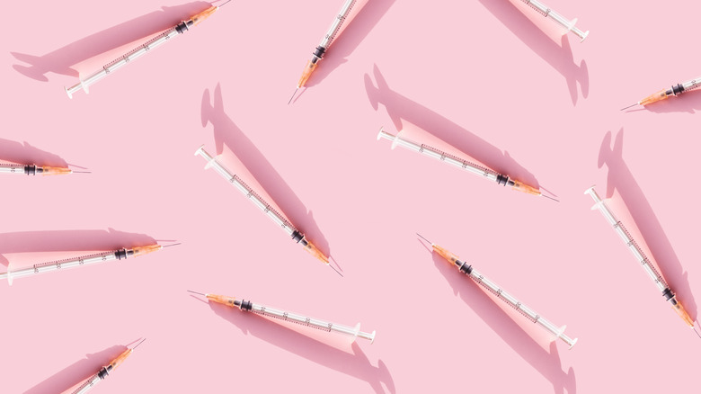 Syringes with a pink background