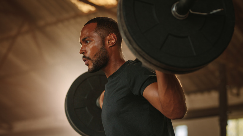 man with barbell at gym