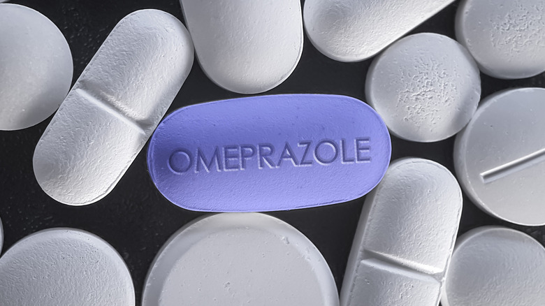 omeprazole tablet on black surface