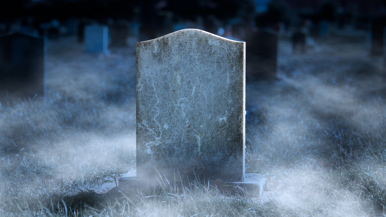 creepy gravestone graveyard at night 