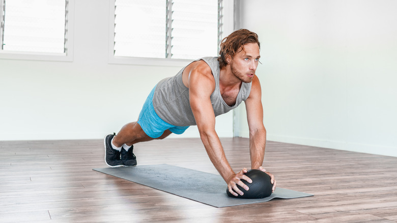 Man exercising with medicine ball