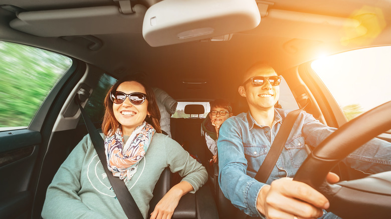 Couple in car with sunglasses on