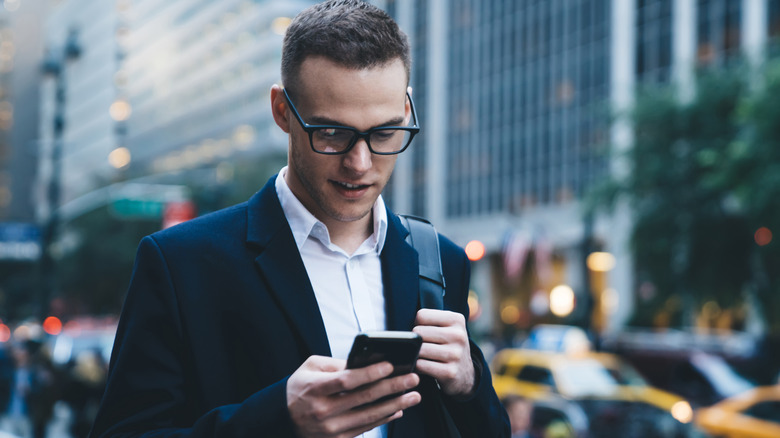 Businessman looking down at smartphone