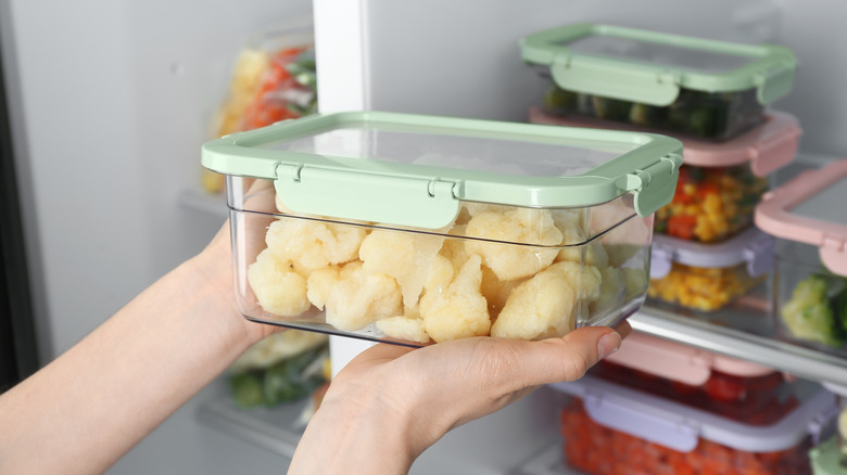 putting cauliflower into a refrigerator