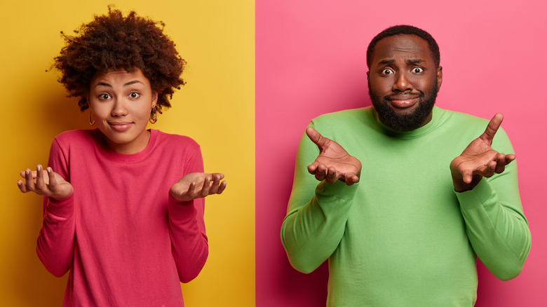 man and woman shrugging