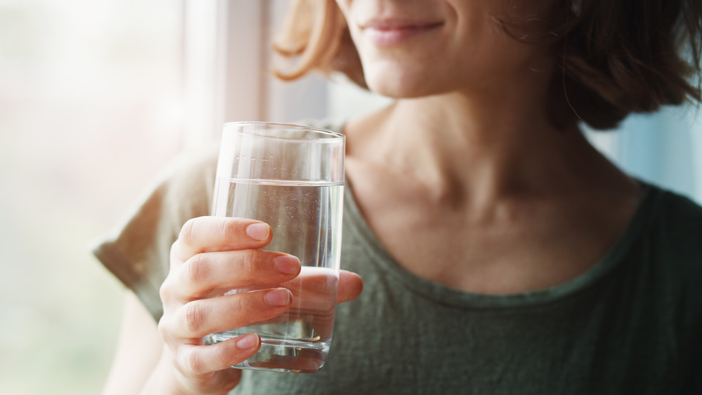 woman holding glass of water