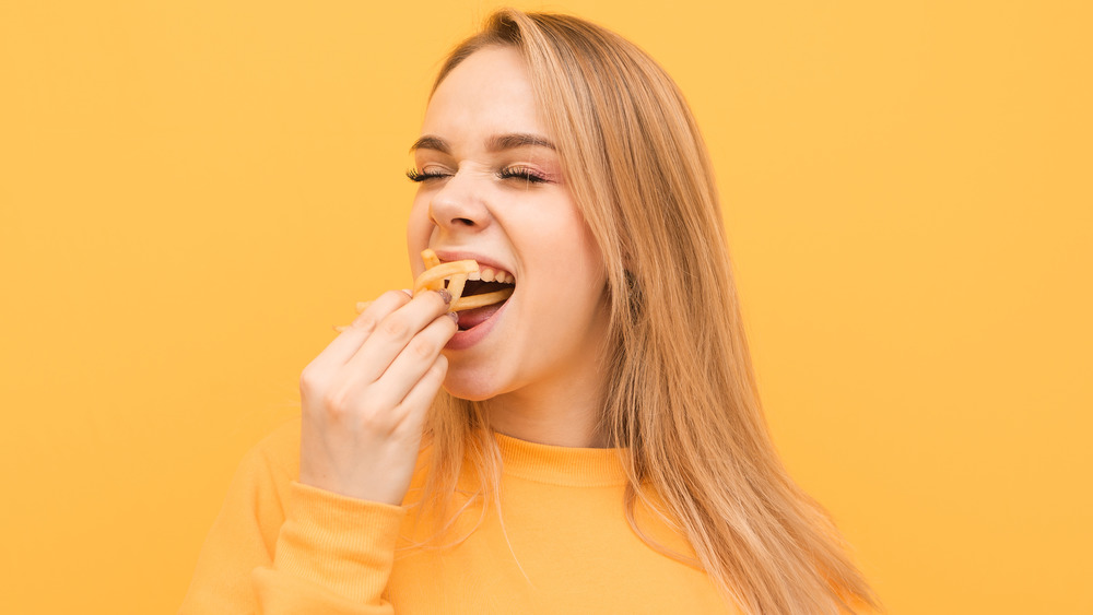 woman eating french fries