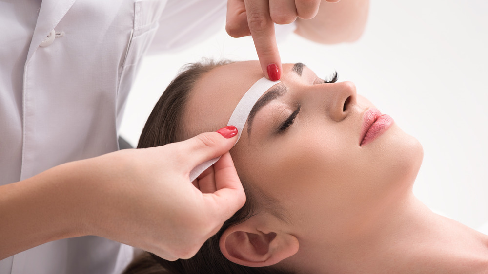 woman getting eyebrows waxed 