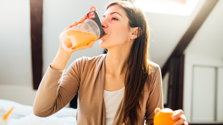 Woman drinking orange shake