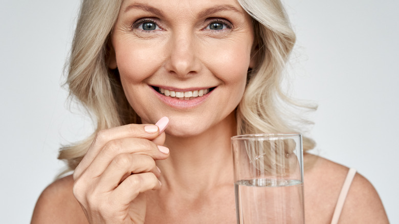 Woman smiling with pill