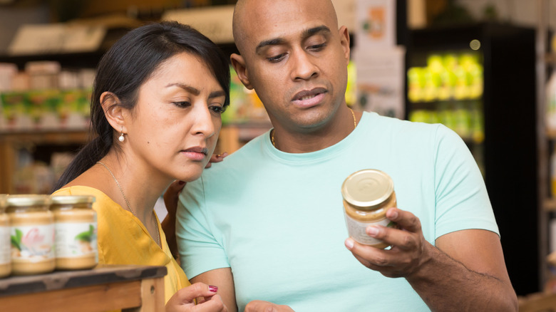 Couple checking nutrient facts on can