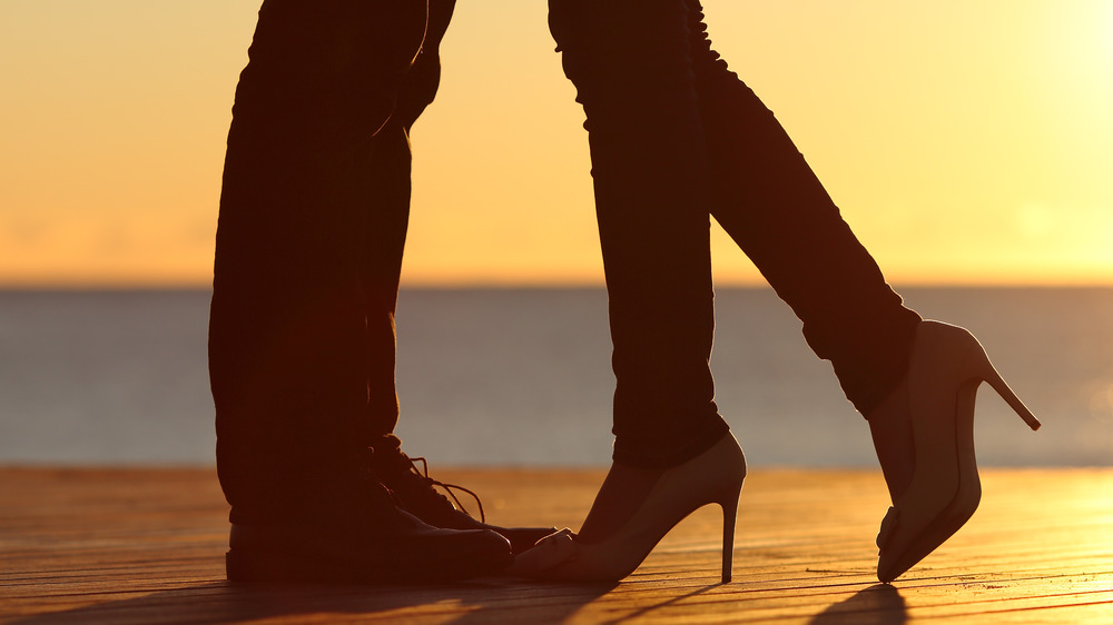 couple kissing at sunset