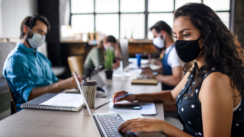 Woman not sure of whether to wear her mask