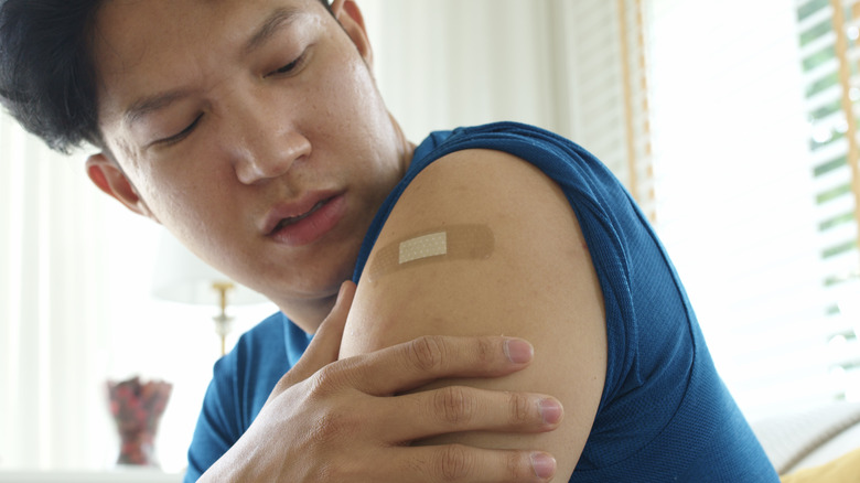 Man frowning at his injection site