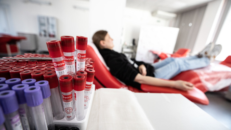 woman donates blood empty vials