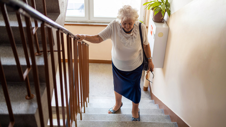 older woman climbing stairs