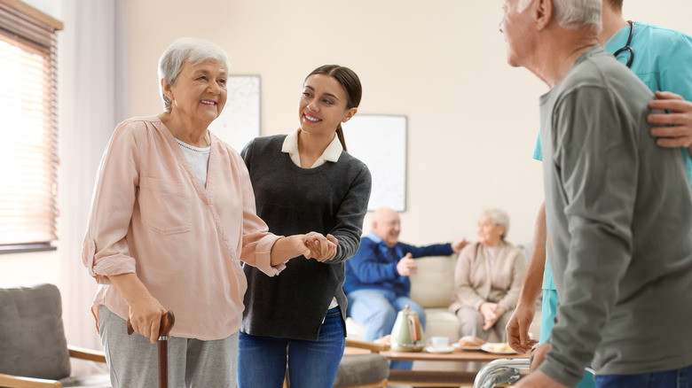 carer helping older woman