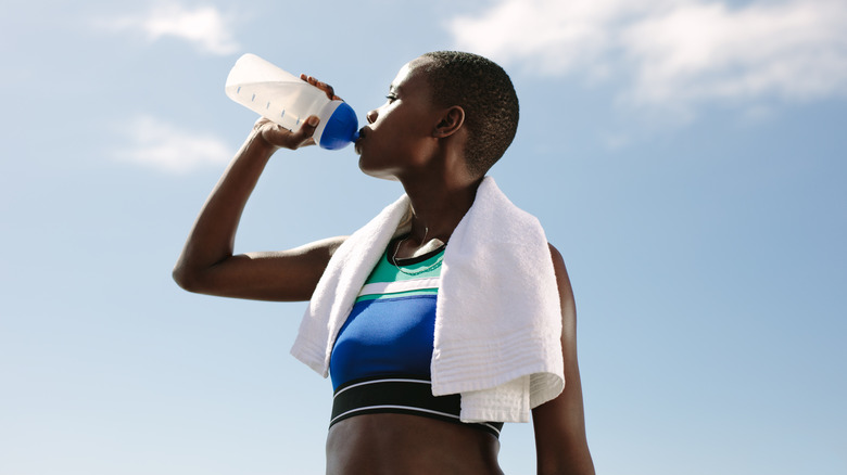 woman drinking water from bottle