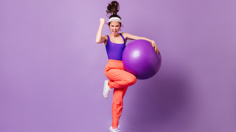 80s fitness girl jumping with exercise ball
