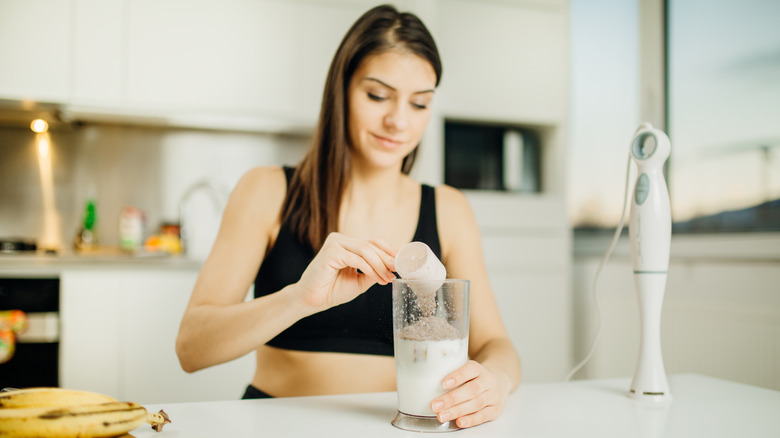 woman making protein shake