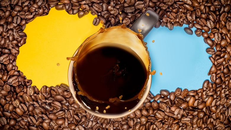 coffee cup surrounded by beans