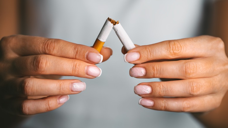 close up hands breaking cigarette