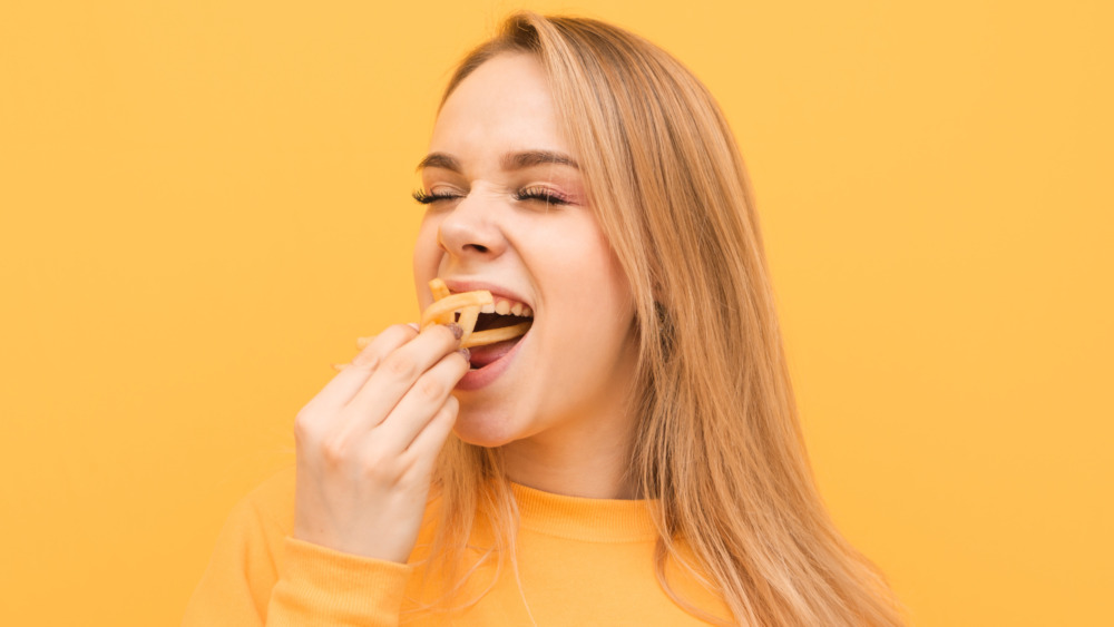 woman eating fries