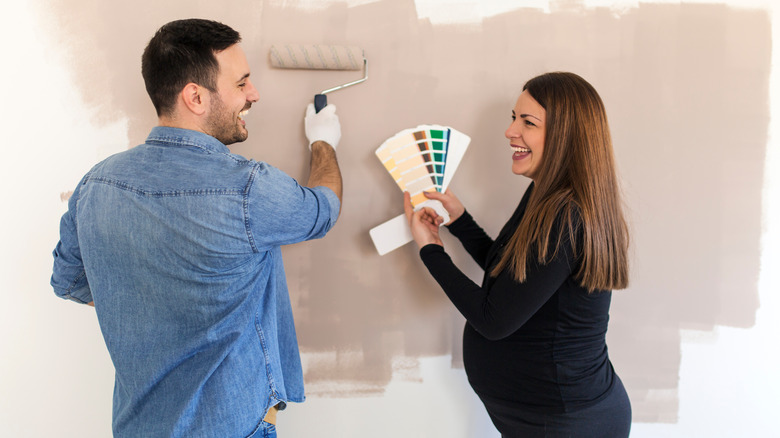 pregnant couple choosing paint color