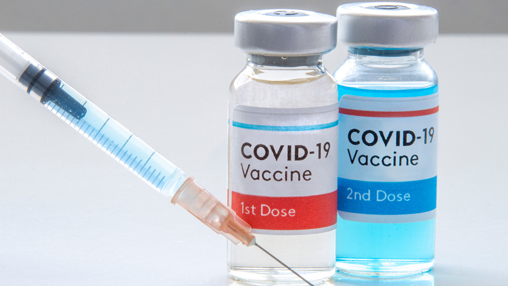 Needle and two vaccine doses in bottles