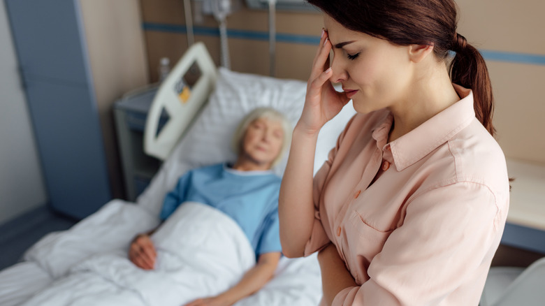 emotional hospital visitor at patient's bedside