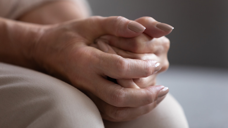 hands clasped while in prayer