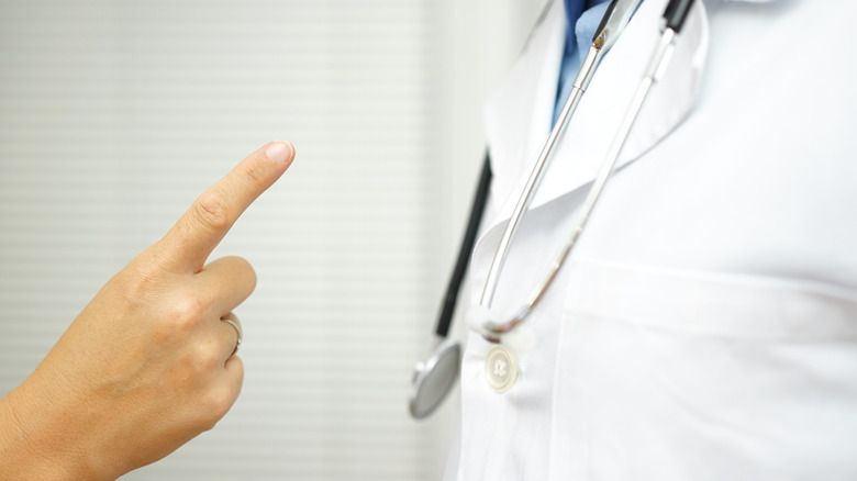 patient pointing finger at doctor