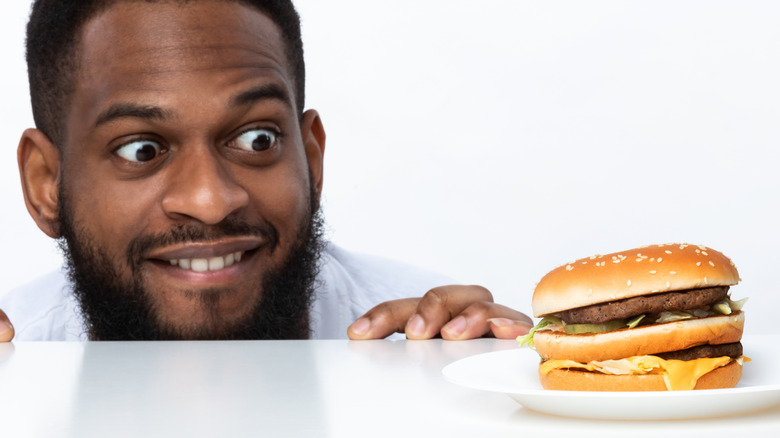 hungry man looking at burger
