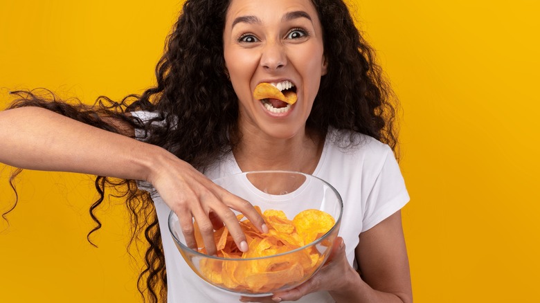 happy woman eating chips