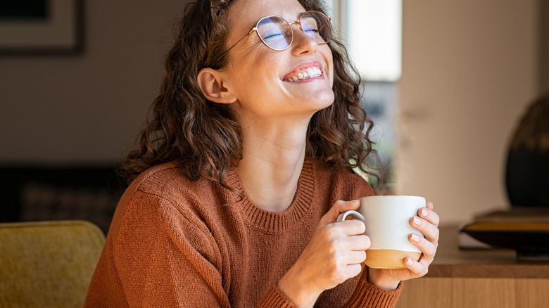 woman smiling with cup
