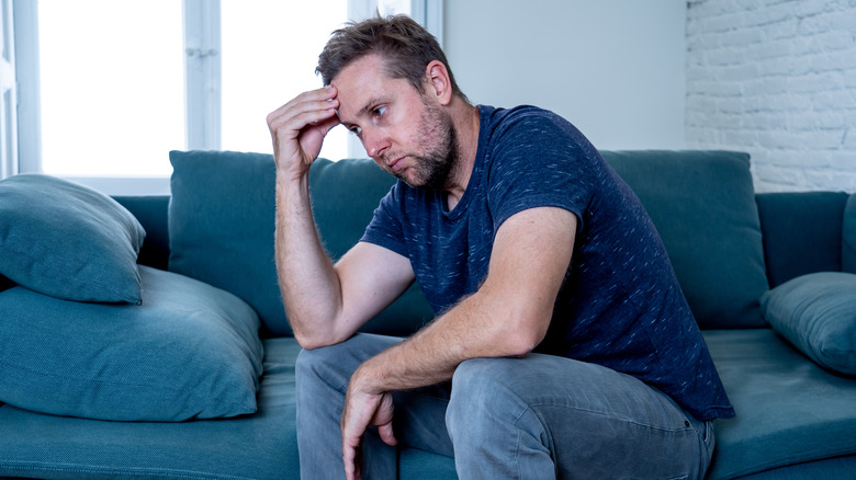 a despondent man in a waiting room