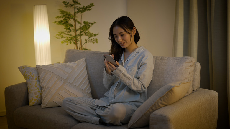 woman on smart phone in pajamas