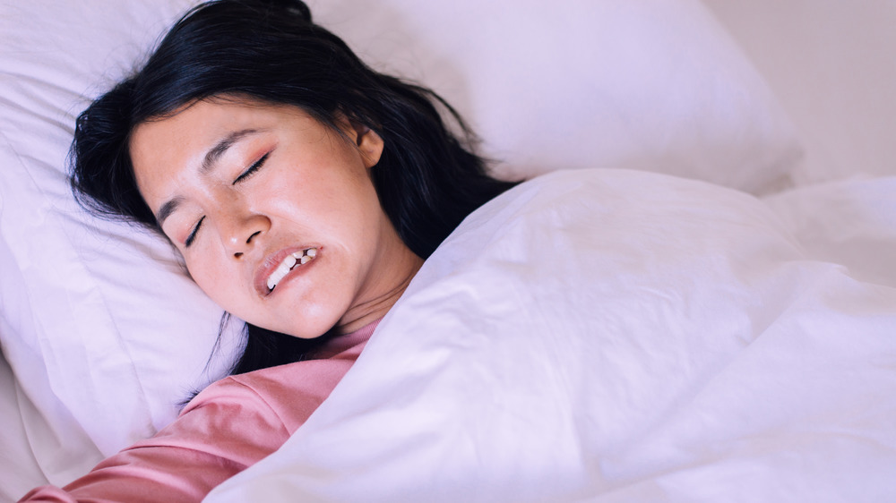 Woman grinding teeth in sleep
