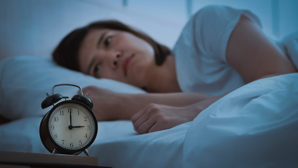 woman with insomnia lying in bed