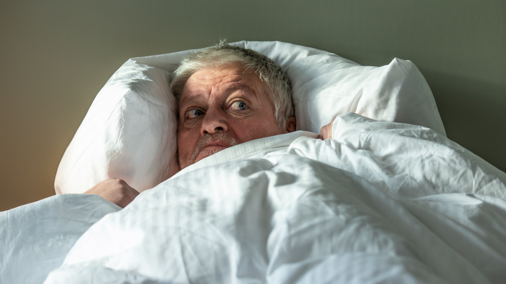older man scared in bed