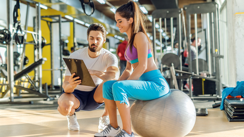 trainer and girl doing paperwork